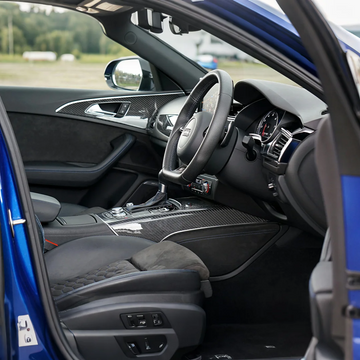 Audi performance car interior with carbon fiber trim and sport steering wheel