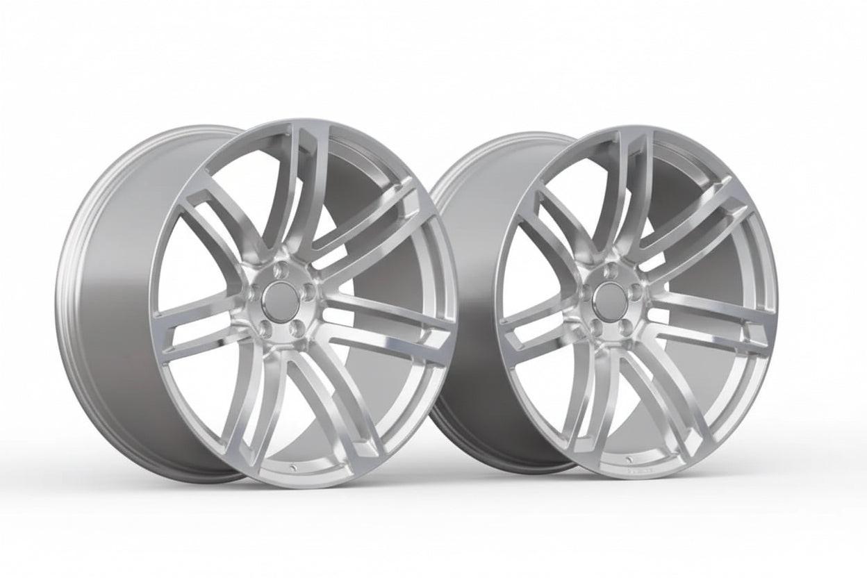 Pair of silver multi-spoke alloy wheels for Audi performance cars on white background