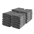 Stack of 24 folded grey microfiber towels for car detailing and cleaning