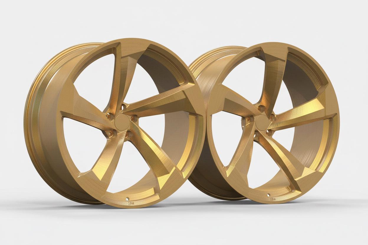Pair of gold alloy 5-spoke Audi performance wheels on white background