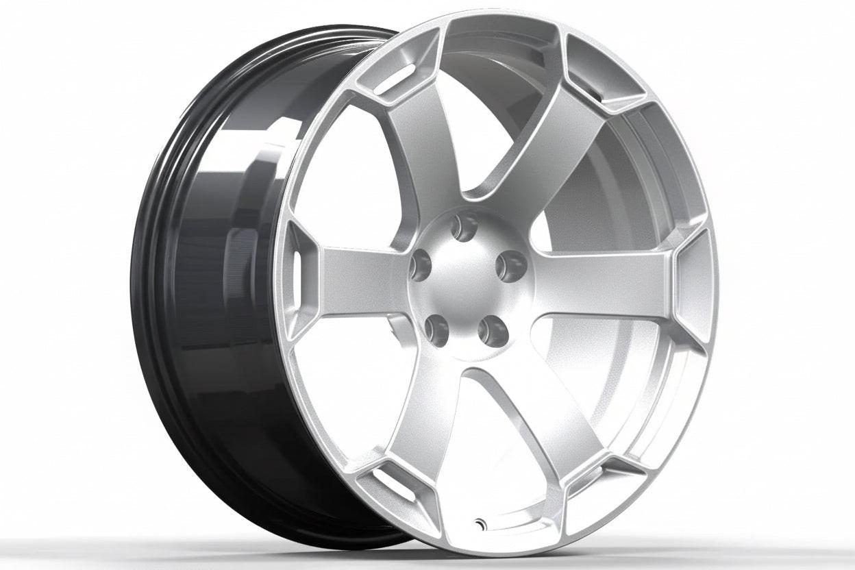 Silver alloy performance wheel rim with a modern split spoke design on white background