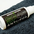 WASH & WHIPS SF45 anti-fog spray for car windshields shown in a spray bottle with label.