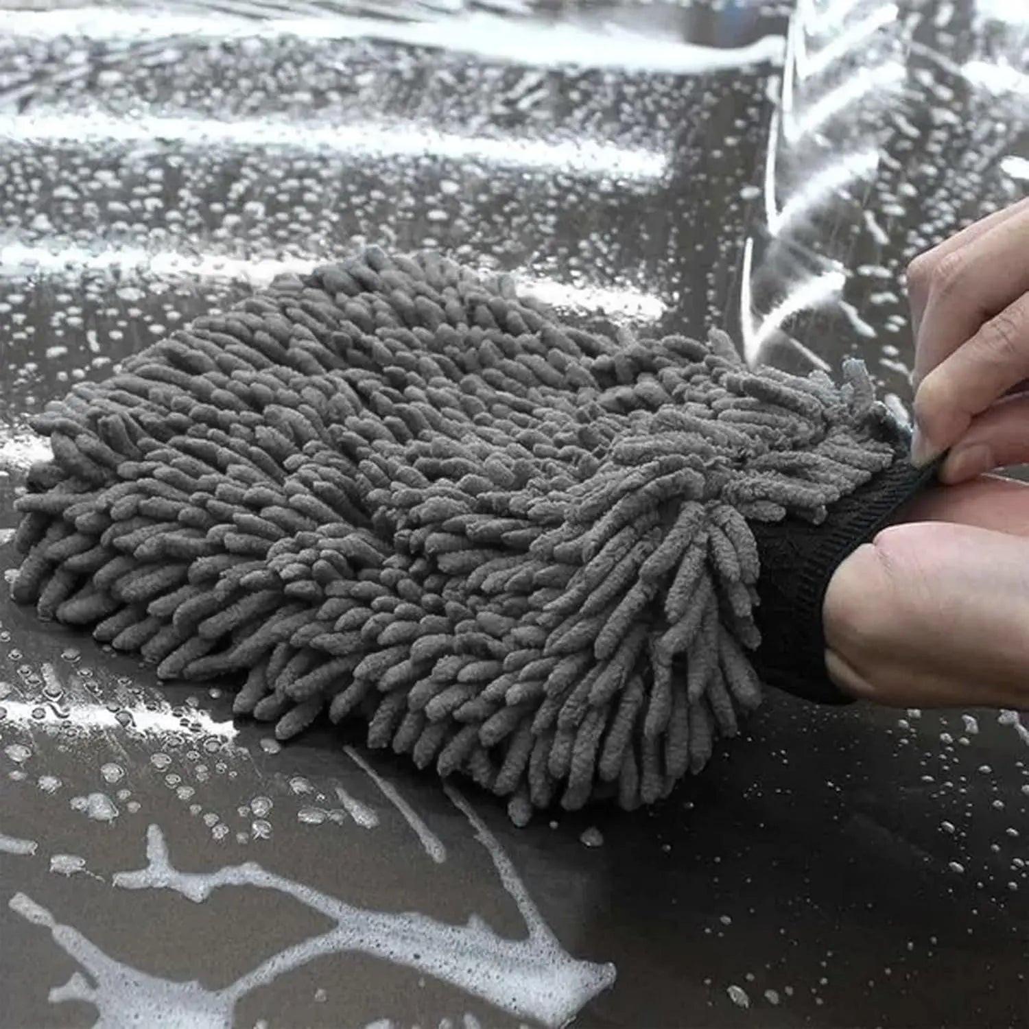 WASH&WHIPS Chenille microfiber wash mitt and black pitstop particle interceptor in a car wash bucket, blue wash mitt with soft scrubbing surface