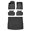Set of black custom-fit Audi floor mats and trunk liner on white background