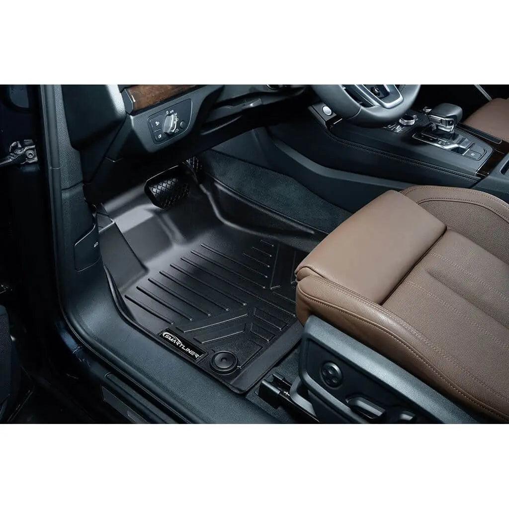 Custom-fit black floor mat in Audi with brown leather seat and modern interior