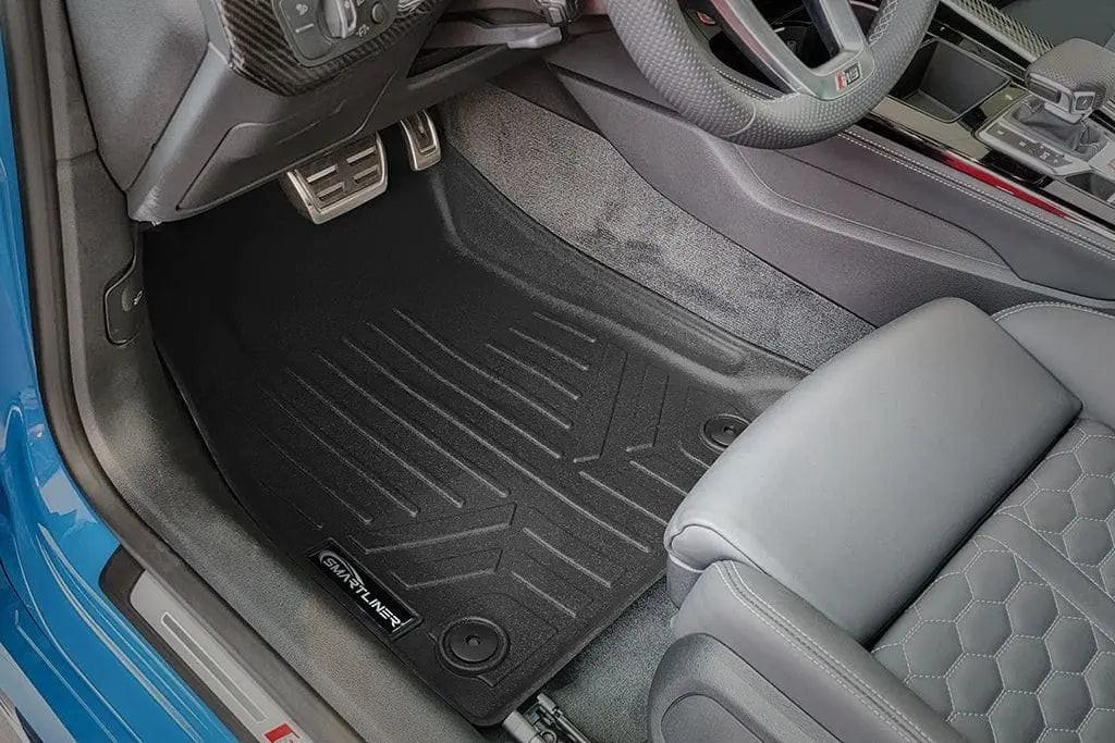 Audi driver side interior featuring custom fit all-weather floor mat and metallic pedals