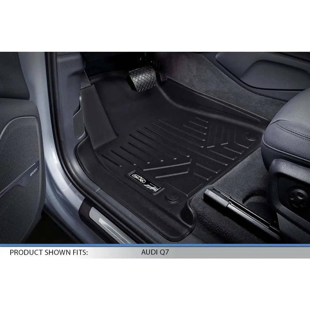 Custom black floor mat installed in Audi Q7 driver side footwell, close-up view