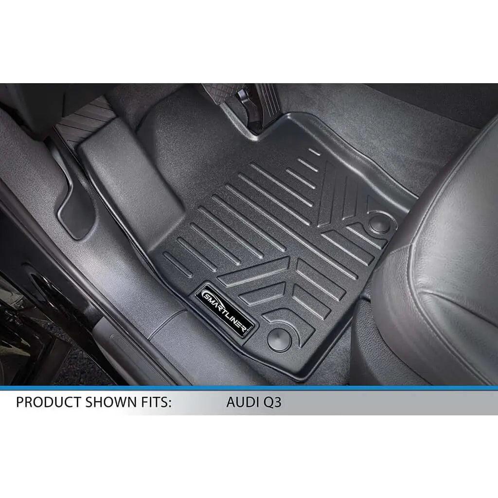 Audi Q3 custom-fit black floor mat with Smartliner logo, installed in car interior.