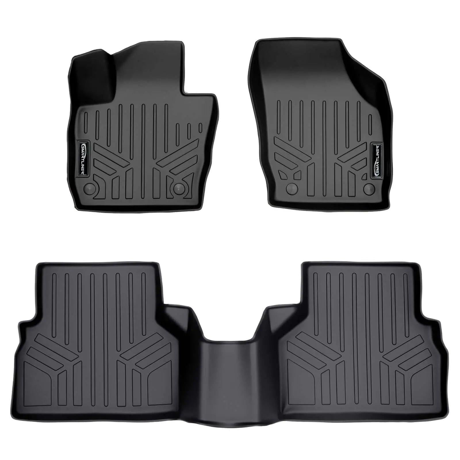 Set of black custom-fit Audi rubber floor mats with raised edges and textured grooves