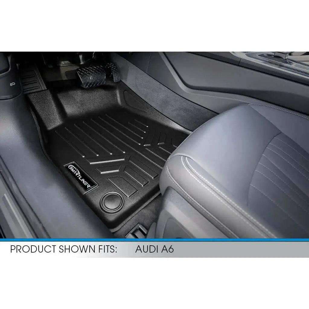 Custom black floor mat installed in Audi A6 front driver seat area with textured pattern.