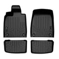 Set of four custom black Audi floor mats with raised edges and textured grooves