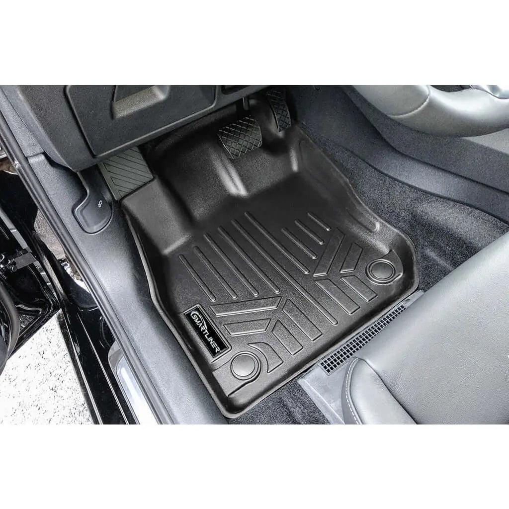 Custom-fit black rubber floor mat installed in Audi car front driver side footwell
