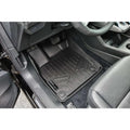 Custom-fit black rubber car floor mat on Audi driver side interior
