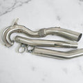Stainless steel Audi S3 and VW Golf R race downpipe kit with clamps on white background