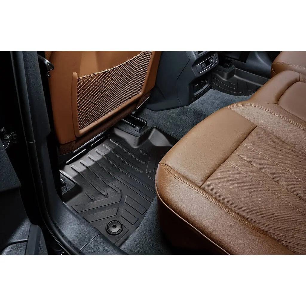 Custom black all-weather floor mat in Audi rear seat with brown leather interior