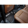 Custom black all-weather floor mat in rear seat of Audi with brown leather interior