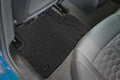 Custom-fit black rear floor mat in Audi with grey leather seat and hexagonal stitching