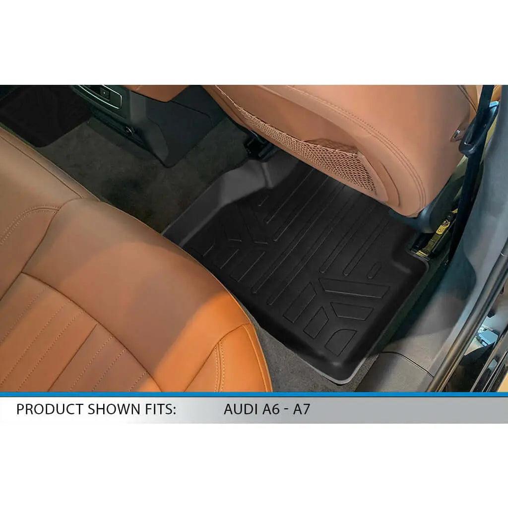 Black rear floor mat installed in Audi A6 or A7 with tan leather seats.