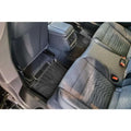 Audi rear car seat interior with custom performance floor mats and black quilted upholstery