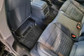 Audi rear seat interior with custom-fit floor mats and premium upholstery