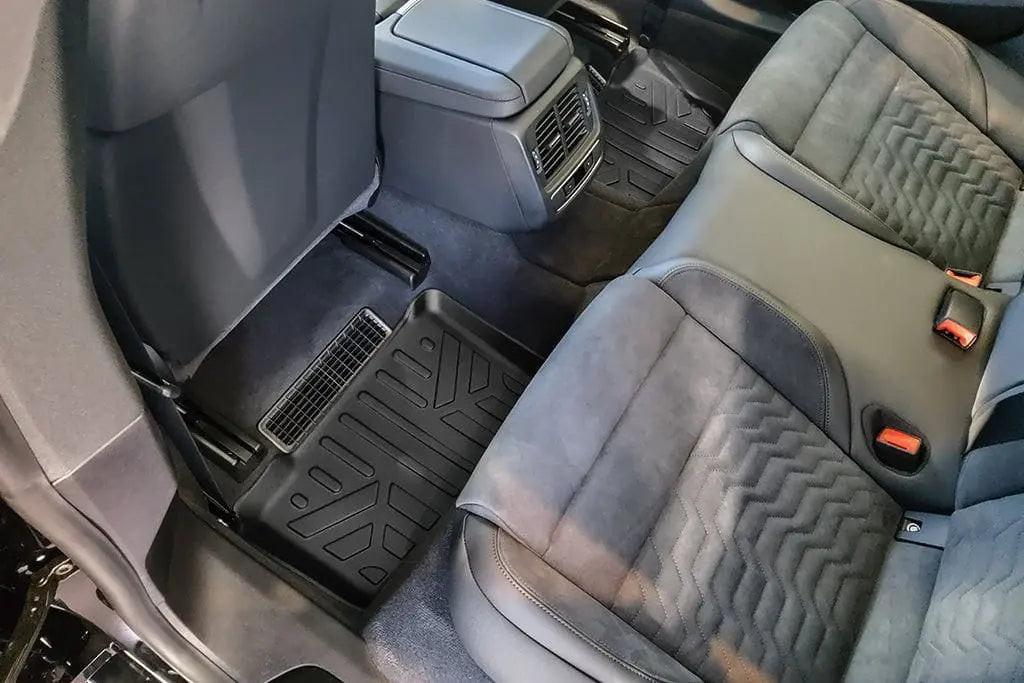 Audi rear seat interior with custom-fit floor mats and premium upholstery