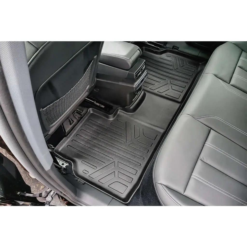 Audi rear seat all-weather floor mats installed, black rubber, showing textured pattern