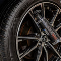 WASH&WHIPS Daytona Tire Coating and Shine applied to a car tire, showcasing a glossy, clean finish on a black tire.
