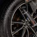 Close-up of car tire and alloy wheel being cleaned with DAYTONA tire shine spray