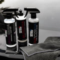 Car detailing products Sonoma ceramic coating, Suzuka rubber and plastic coating, Daytona tire shine bottles with microfiber cloth on car hood