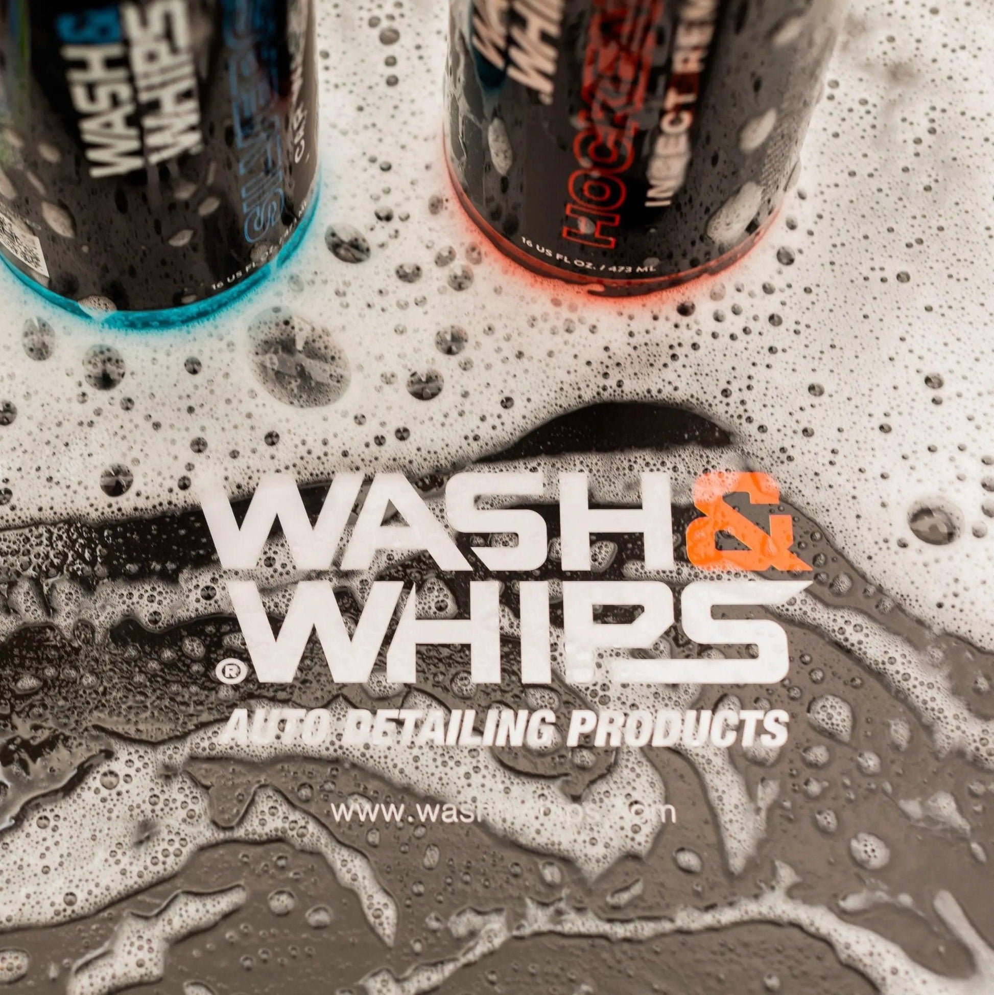 Car wash and detailing products with soap suds, featuring Wash & Whips branding