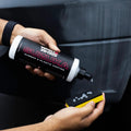 Applying Wash & Whips Suzuka rubber and plastic coating to black sponge for car trim care