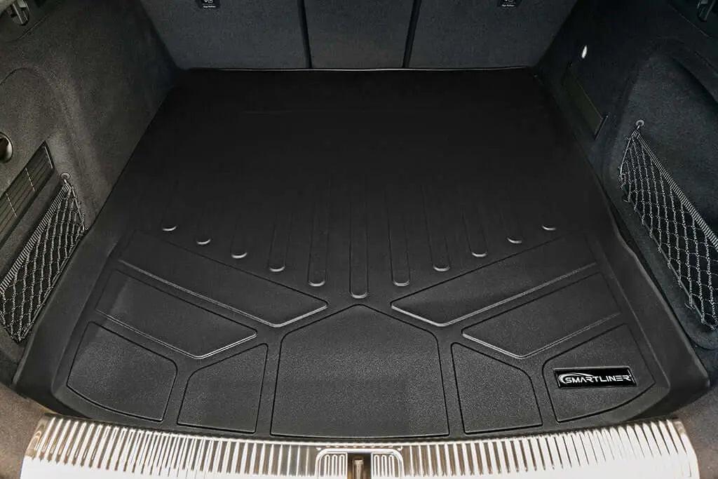 Black custom-fit cargo trunk mat liner installed in car boot, embossed SMARTLINER logo visible