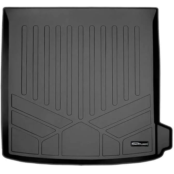 Black custom-fit Audi trunk mat with raised edges and textured, grooved surface.