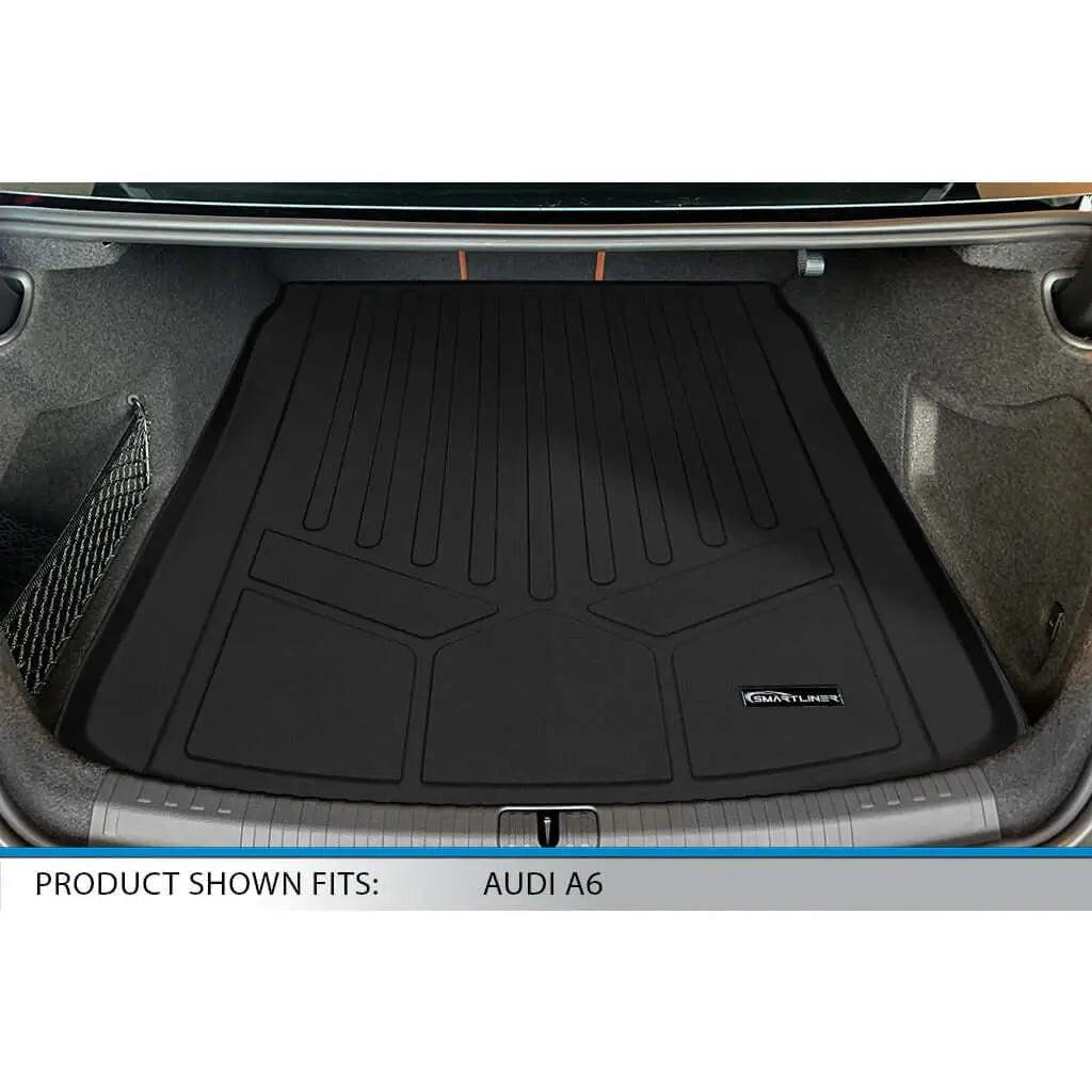 Audi A6 trunk with custom-fit black rubber cargo mat, Smartliner logo visible.