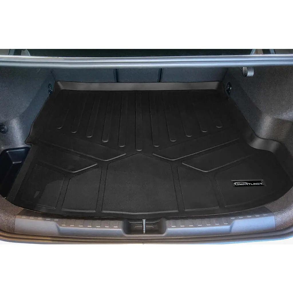 Custom fit black trunk liner mat installed in car trunk with raised edges