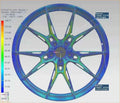 Color-mapped Audi performance wheel stress analysis showing structural load distribution