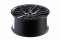 Glossy black multi-spoke alloy wheel rim for Audi performance vehicles, isolated on white