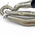 Stainless steel Audi performance downpipe with welded joints and smooth bends on white background.