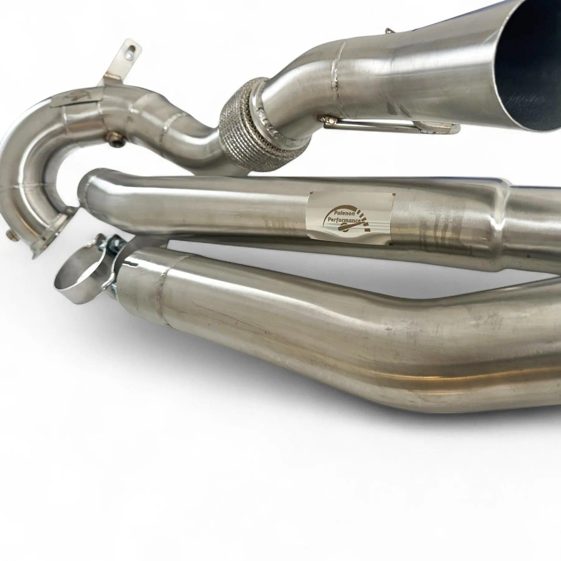Stainless steel Audi performance downpipe with welded joints and smooth bends on white background.