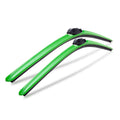 Pair of green aerodynamic windshield wiper blades on white background
