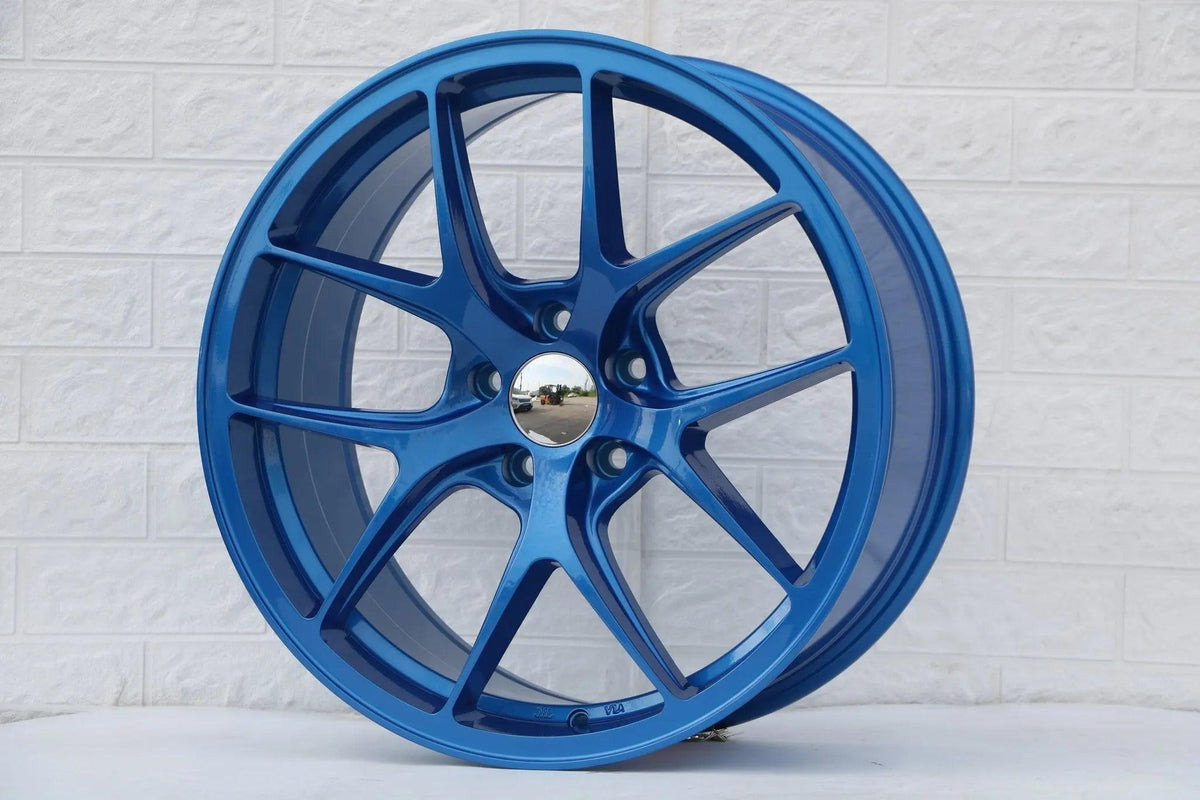 Blue 19-inch Vortex Style Wheels by WheeloutletNJ, showcasing sleek, aerodynamic design and vibrant finish.