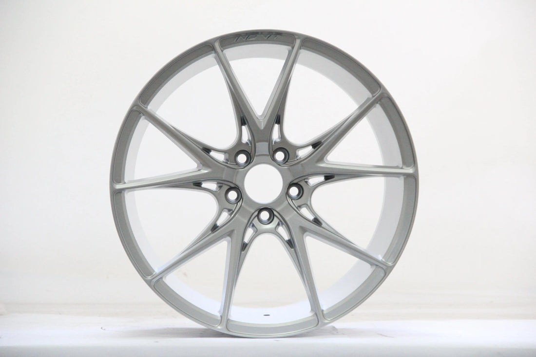 silver multi-spoke alloy wheel for Audi performance car, isolated on white background