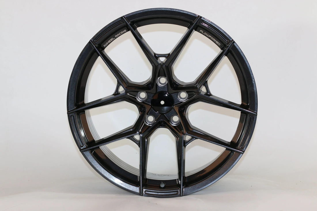 Gloss black flow formed alloy wheel with split-spoke design on white background