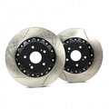 Pair of performance Audi brake rotors with slotted design on white background