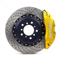 High-performance drilled brake rotor with yellow caliper for Audi vehicles
