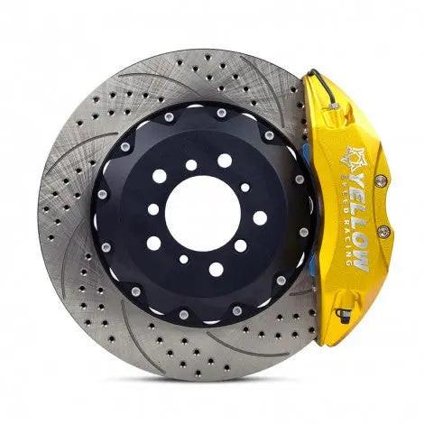 High-performance drilled and slotted brake rotor with yellow caliper for Audi vehicles