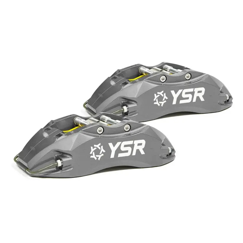Pair of grey YSR performance brake calipers for Audi, automotive parts on white background