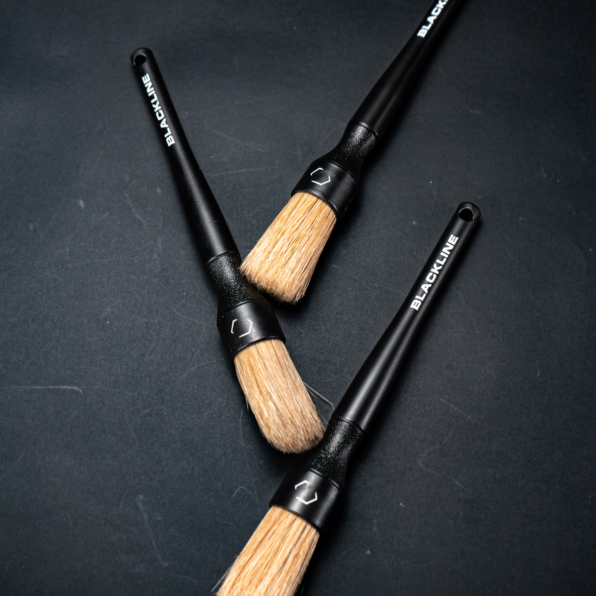 Blackline Car Care boars hair detailing brushes set, showing close-up of natural boar's hair brush heads and black handles.