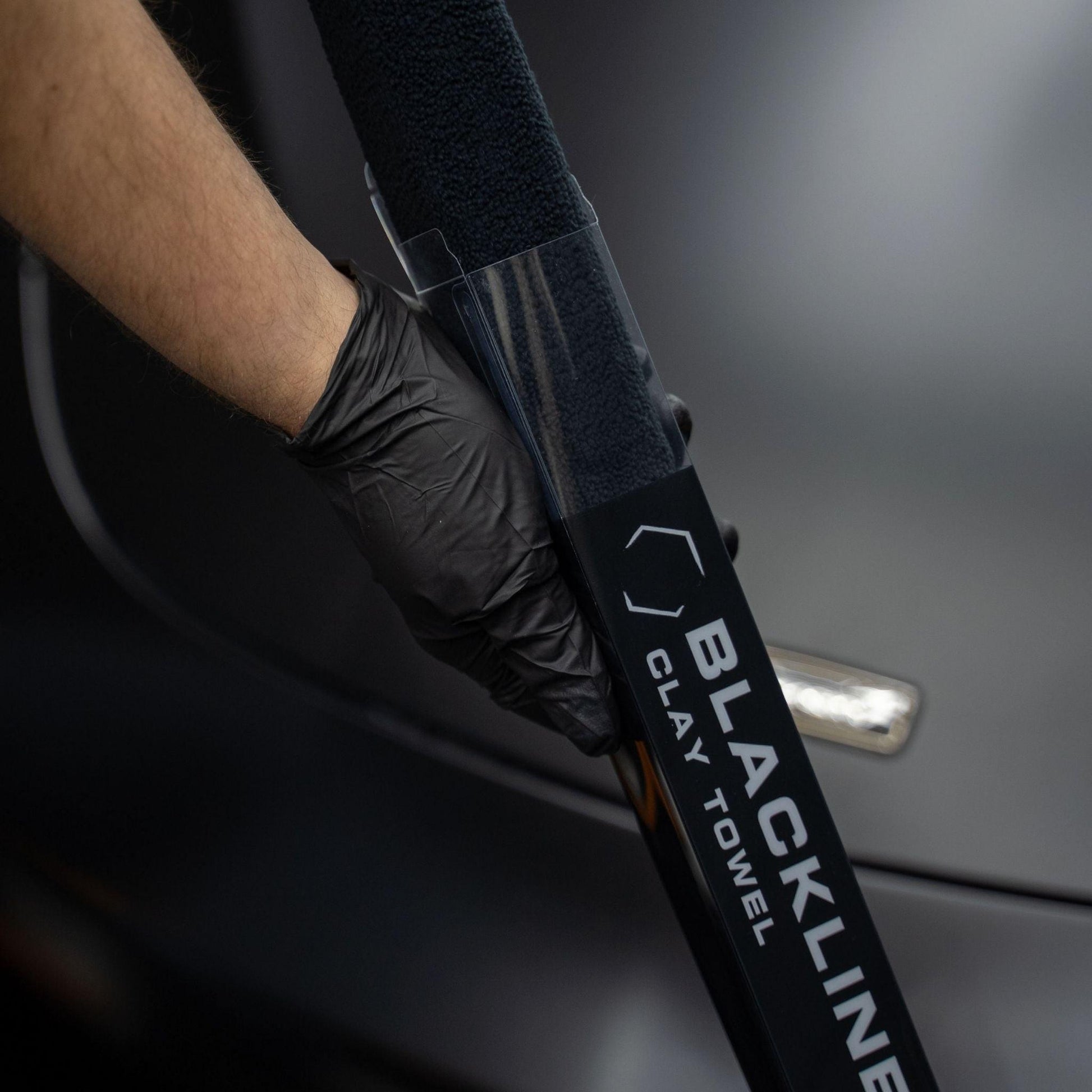 Blackline Synthetic Clay Towel for car detailing, black microfiber cloth designed to remove contaminants from vehicle surfaces.