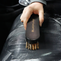 Blackline Car Care BLACKLINE® leather brush with black bristles and ergonomic handle for cleaning leather surfaces.
